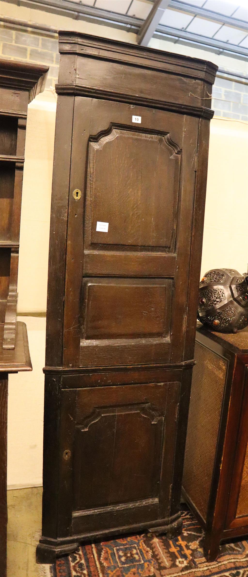 A 17th century style oak corner cupboard, width 58cm, depth 30cm, height 190cm